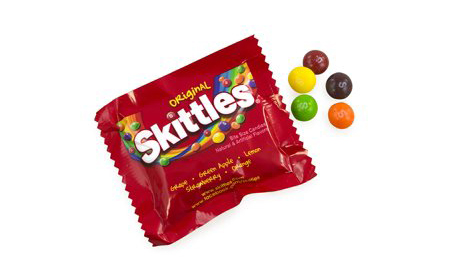 Skittles mini packet with all flavors laid out on table