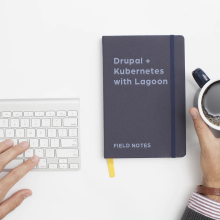 computer keyboard with notebook with field notes phrase and cup of coffee