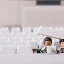 Two lego characters drinking coffee in a keyboard