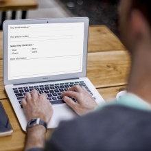 Man coding form fields on laptop