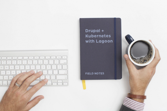 computer keyboard with notebook with field notes phrase and cup of coffee