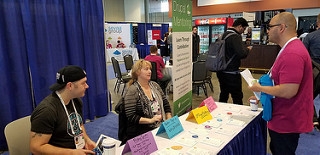 Dan and AmyJune sitting at the DrupalCon Mentoring table talking with a potential sprinter.