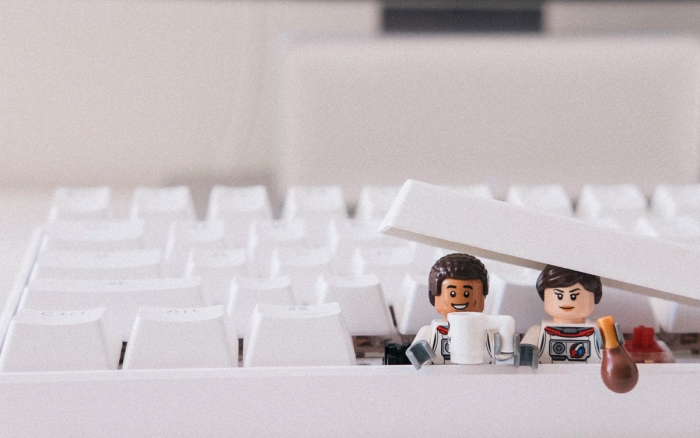 Two lego characters drinking coffee in a keyboard